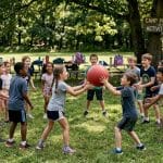 Children playing outdoor camp team-building game