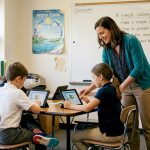 Teacher guides students in coding lesson