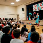 Elementary students watching interactive school assembly show